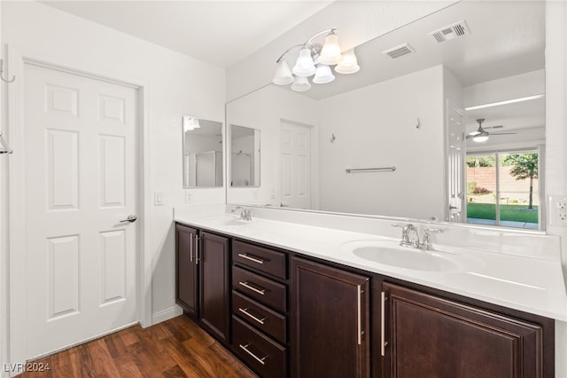 bathroom featuring hardwood / wood-style floors, ceiling fan with notable chandelier, and vanity