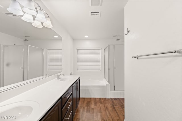 bathroom featuring vanity, wood-type flooring, and shower with separate bathtub