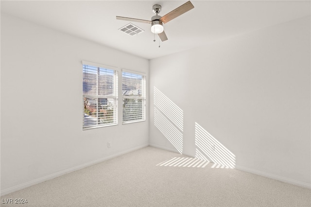 carpeted empty room featuring ceiling fan