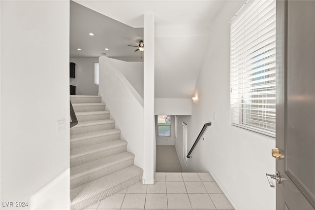 stairs with tile patterned floors and ceiling fan