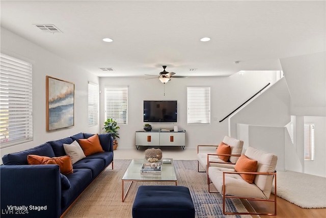 living room featuring ceiling fan and plenty of natural light