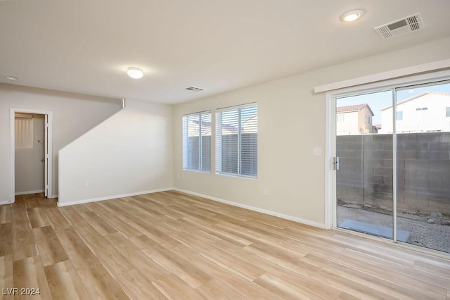 empty room featuring light hardwood / wood-style flooring and a healthy amount of sunlight