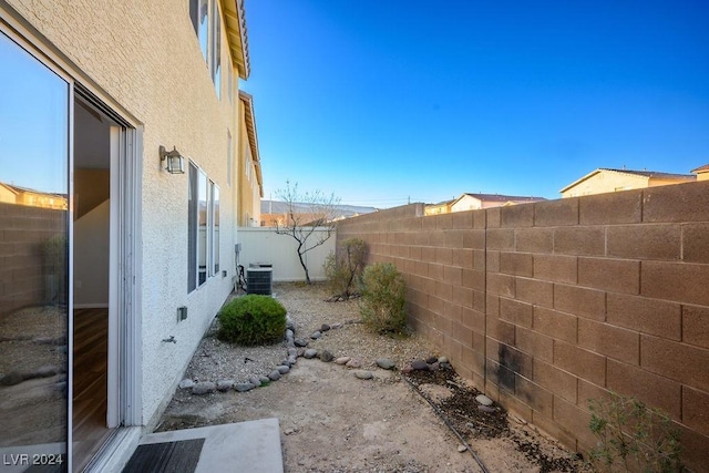 view of side of home featuring central AC