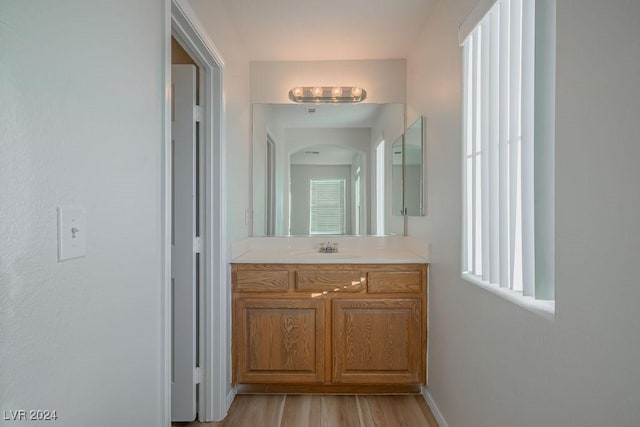 bathroom featuring vanity and hardwood / wood-style flooring