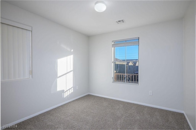 unfurnished room featuring carpet