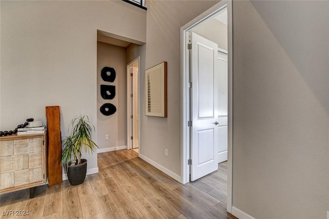 corridor with light hardwood / wood-style flooring