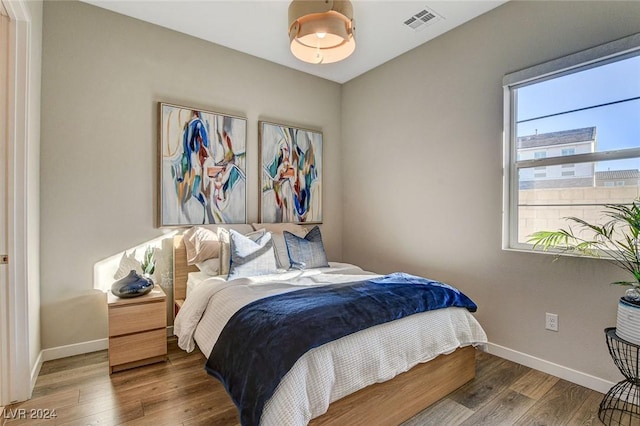 bedroom with hardwood / wood-style floors