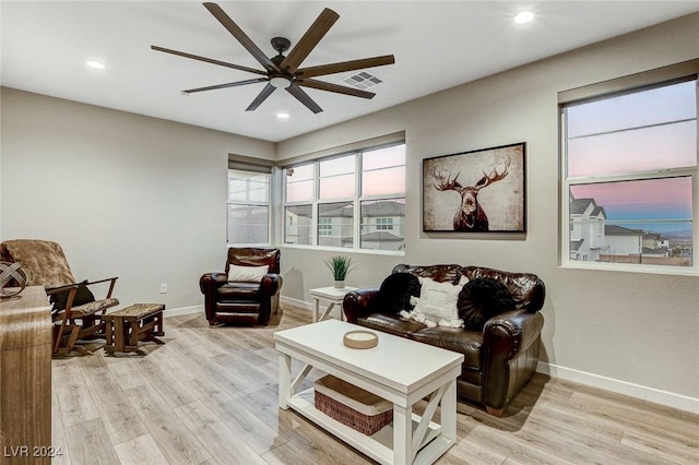 living room with ceiling fan and light hardwood / wood-style floors