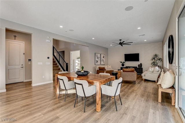 dining area with ceiling fan and light wood-type flooring