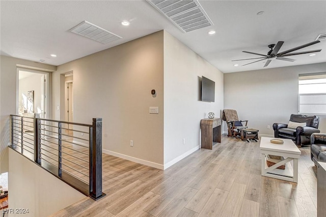 living room with ceiling fan and light wood-type flooring