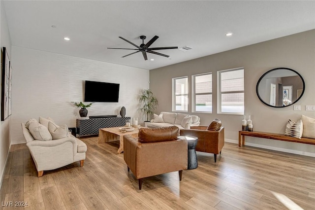 living room featuring ceiling fan and light hardwood / wood-style floors