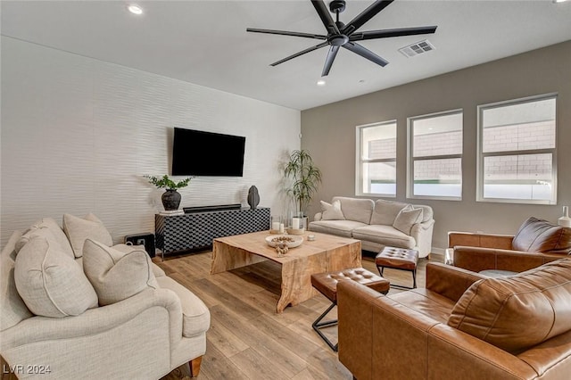 living room featuring ceiling fan and light hardwood / wood-style flooring