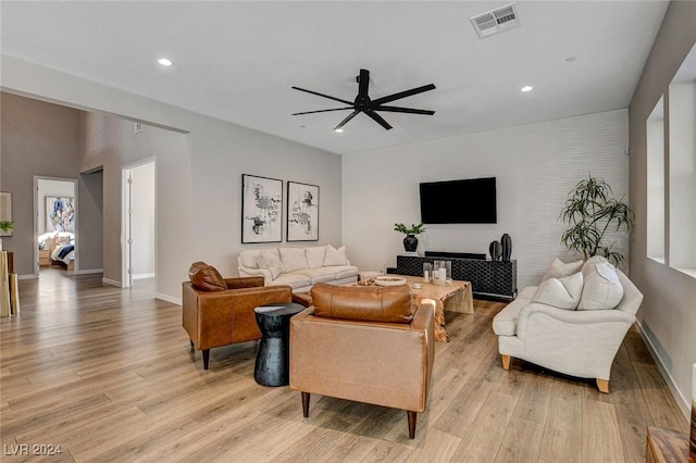 living room with ceiling fan and light wood-type flooring