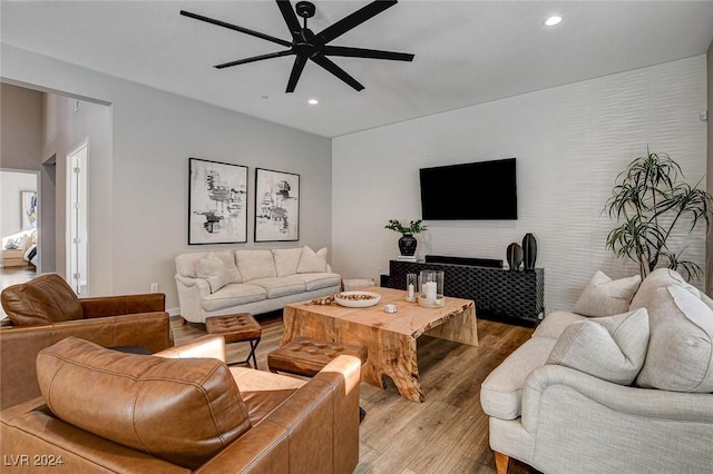 living room featuring ceiling fan and light wood-type flooring