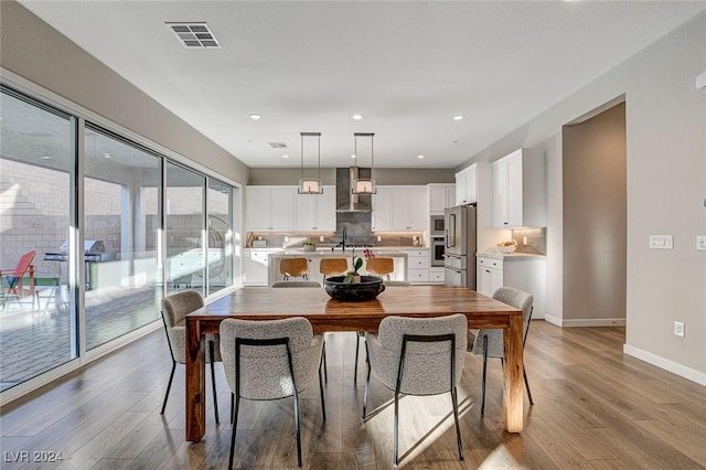 dining area featuring hardwood / wood-style flooring and sink