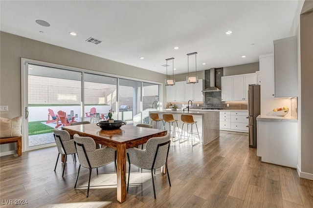 dining room featuring light hardwood / wood-style flooring and sink