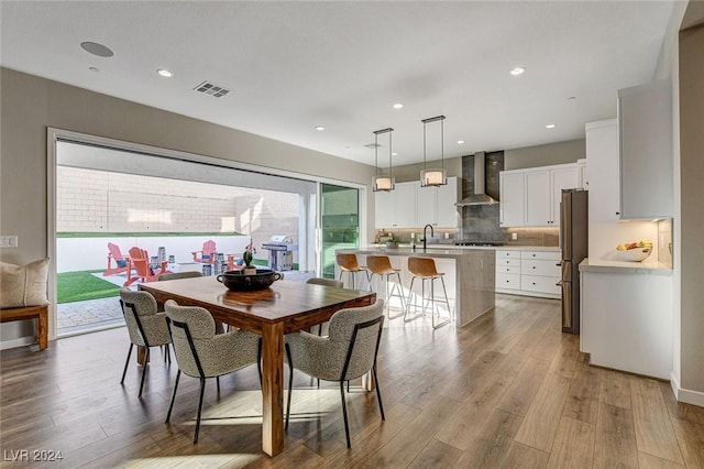 dining area featuring sink and light wood-type flooring