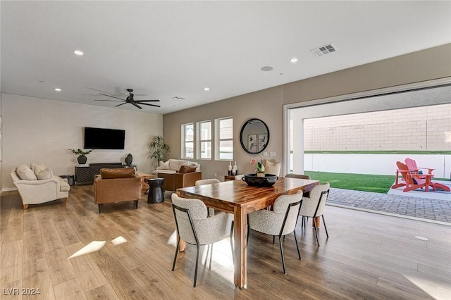 dining area with ceiling fan and light hardwood / wood-style floors