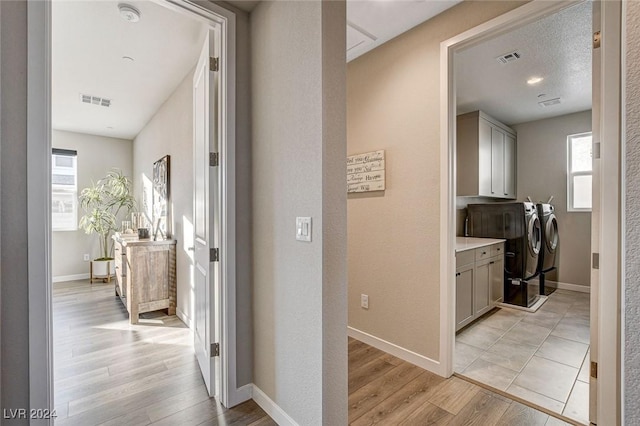 hall featuring washer and dryer and light hardwood / wood-style floors