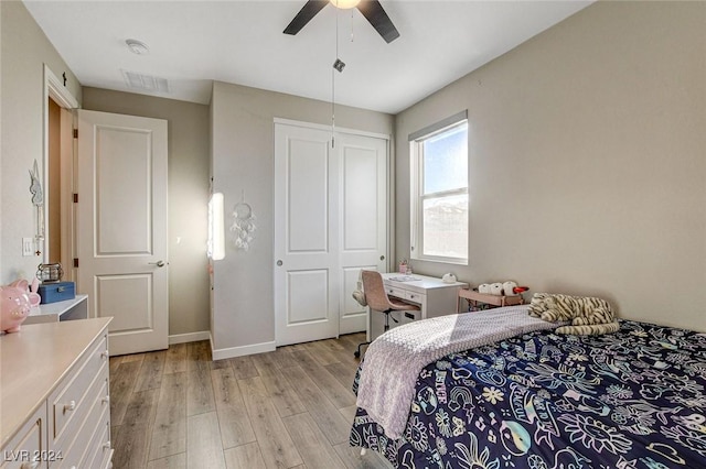 bedroom with a closet, light hardwood / wood-style flooring, and ceiling fan