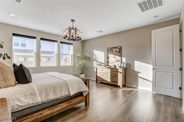 bedroom featuring hardwood / wood-style flooring and a notable chandelier