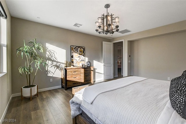 bedroom featuring dark hardwood / wood-style floors and a notable chandelier