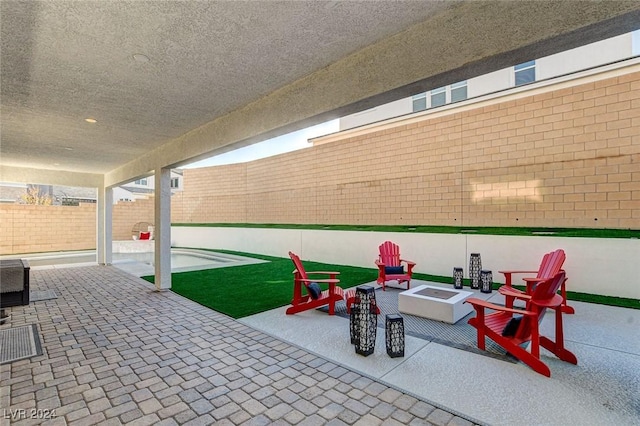 view of patio / terrace featuring an outdoor fire pit