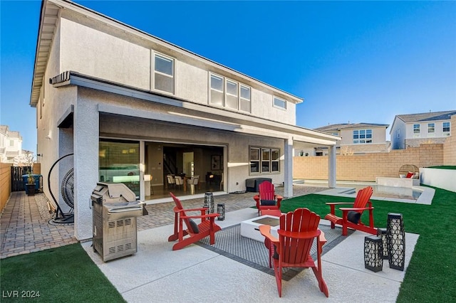 rear view of property with a lawn and a patio