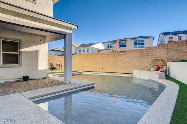 view of swimming pool with pool water feature