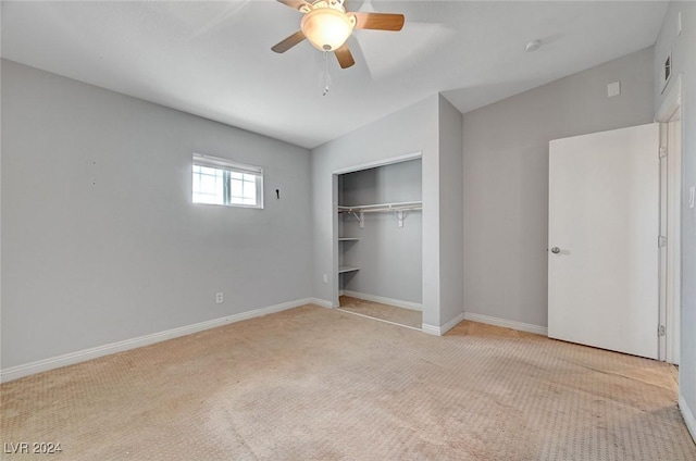 unfurnished bedroom featuring ceiling fan, lofted ceiling, light carpet, and a closet