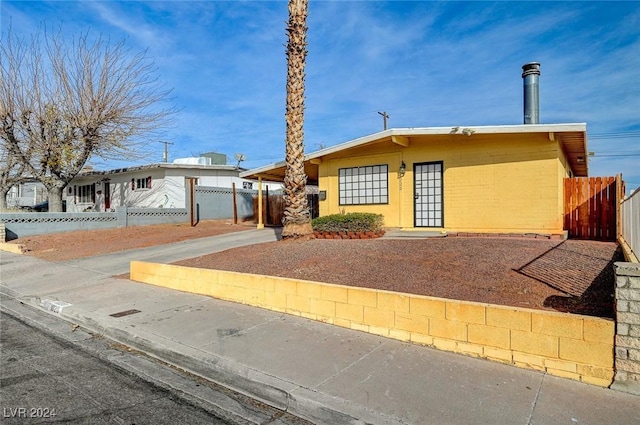 ranch-style home featuring a carport