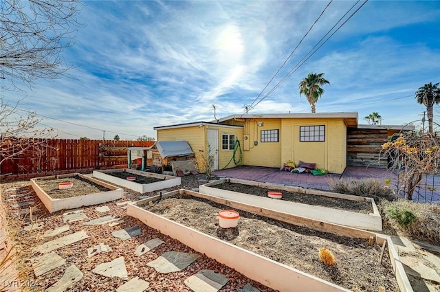 rear view of house featuring a storage unit