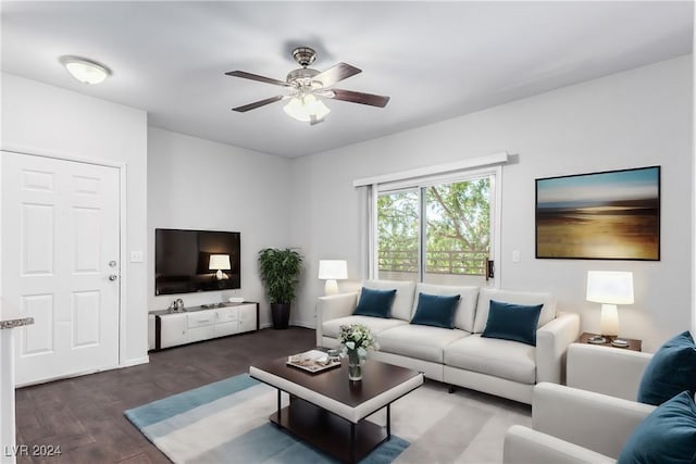 living room with ceiling fan and dark hardwood / wood-style flooring