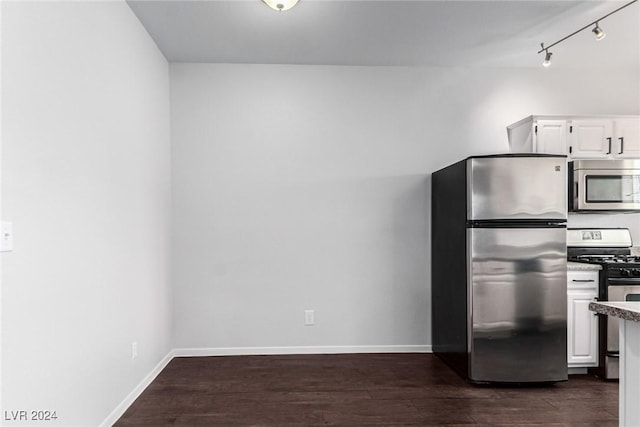 kitchen with white cabinets, stainless steel appliances, and dark wood-type flooring