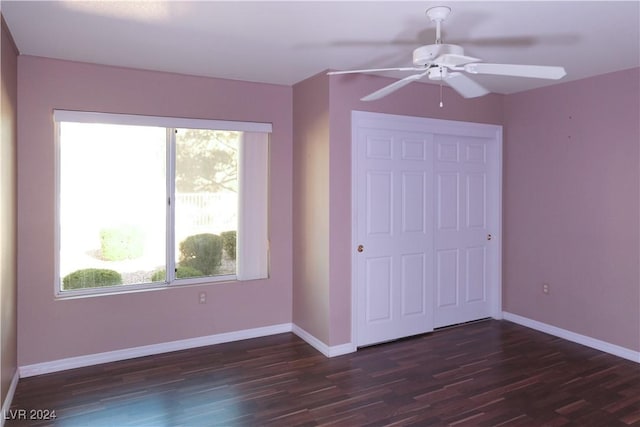 unfurnished bedroom with a closet, dark hardwood / wood-style floors, and ceiling fan