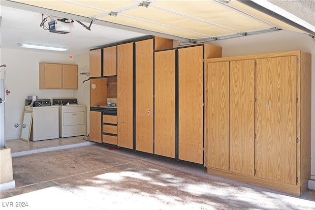 garage with washer and dryer and a garage door opener