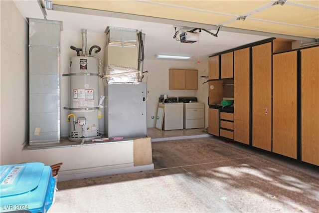 garage featuring washing machine and dryer, water heater, and a garage door opener