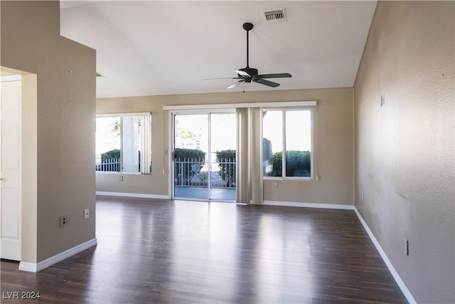 empty room featuring dark hardwood / wood-style floors, ceiling fan, and lofted ceiling