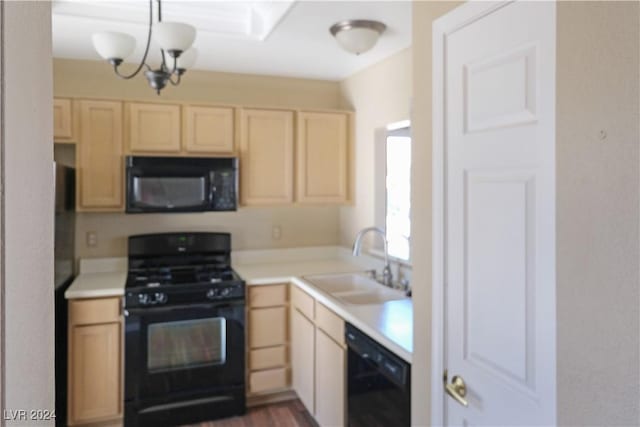 kitchen featuring light brown cabinetry, sink, black appliances, and a notable chandelier