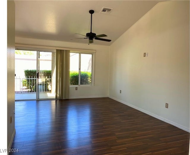 spare room featuring wood finished floors, vaulted ceiling, baseboards, visible vents, and a ceiling fan