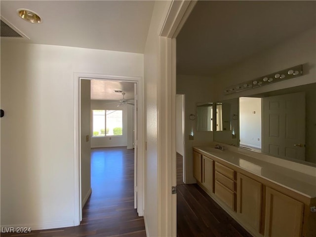bathroom featuring vanity, visible vents, wood finished floors, and baseboards