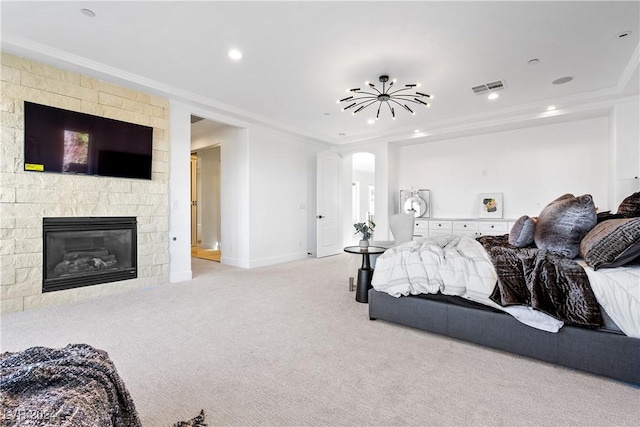 bedroom featuring a stone fireplace, light colored carpet, and ornamental molding