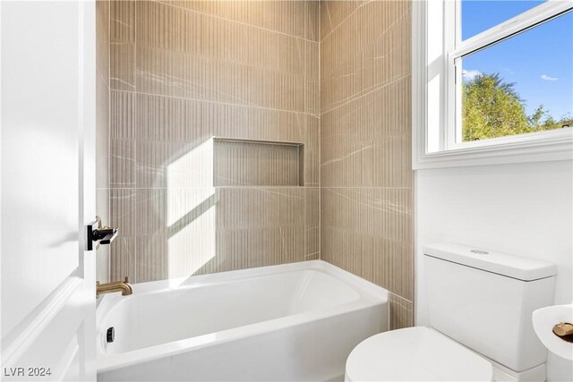 bathroom featuring shower / washtub combination and toilet