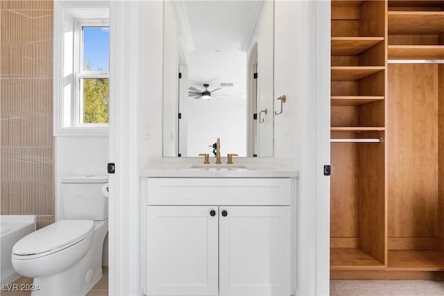 bathroom featuring tile patterned flooring, vanity, toilet, and ceiling fan