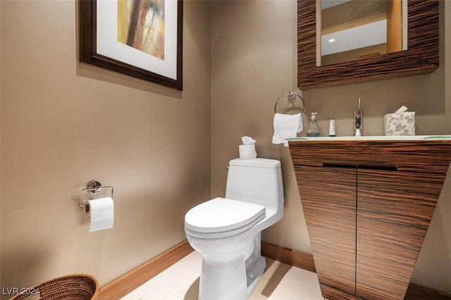 bathroom featuring vanity, wood-type flooring, and toilet