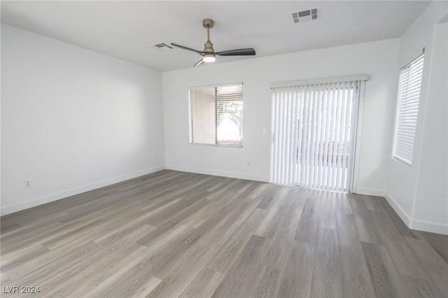 unfurnished room featuring hardwood / wood-style floors and ceiling fan