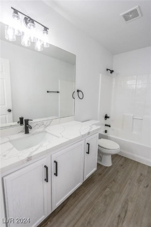 full bathroom featuring wood-type flooring, vanity, shower / bath combination, and toilet