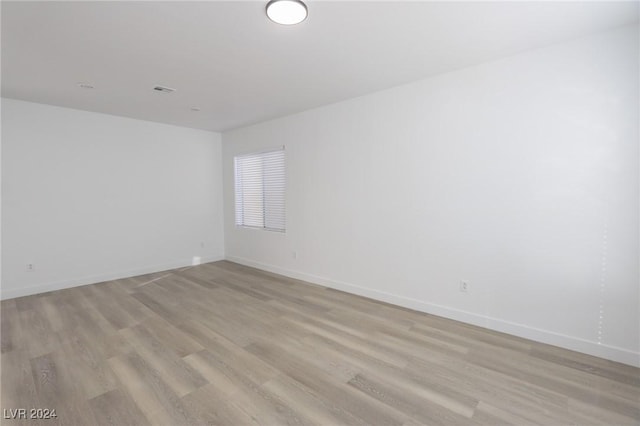 empty room with light hardwood / wood-style flooring