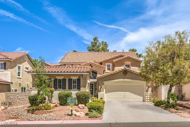 mediterranean / spanish house with a garage