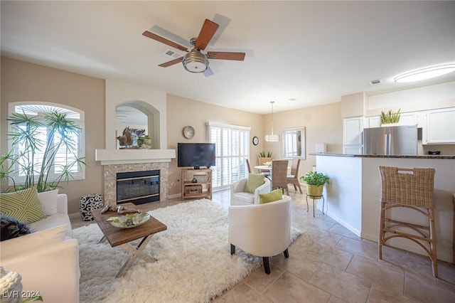 living room with ceiling fan and light tile patterned floors